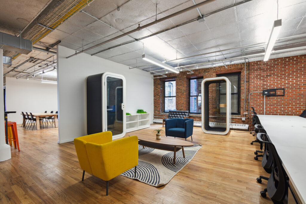 a coworking space in chelsea with phone booths, lounge areas, and communal elements 
